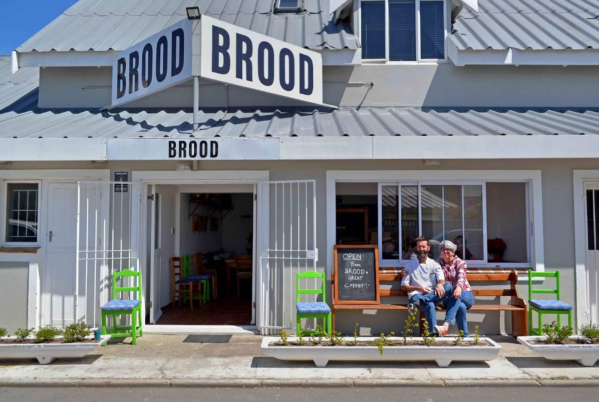 Couple sitting outside BROOD's charming white storefront