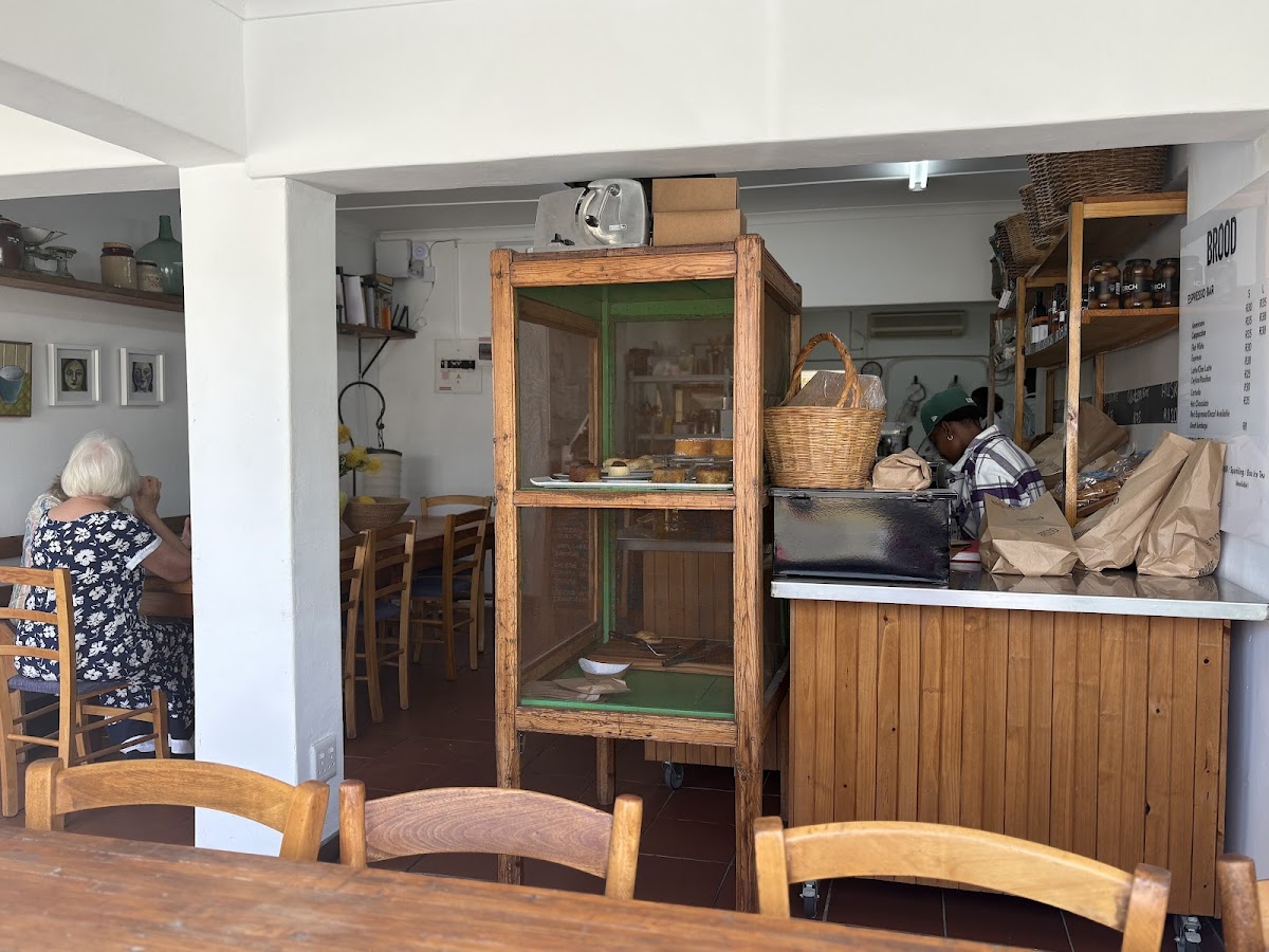 Rustic open-air seating area inside BROOD with wooden tables