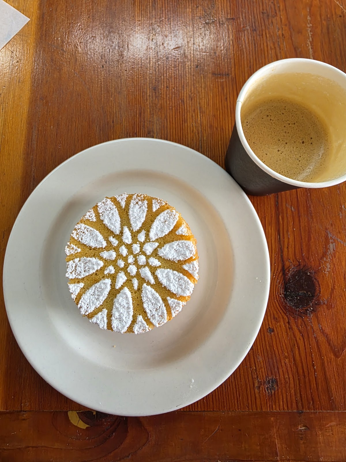 Stenciled powdered-sugar cake paired with coffee at BROOD